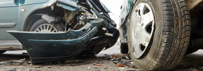 Damaged vehicles involved in a car accident with a crushed front bumper